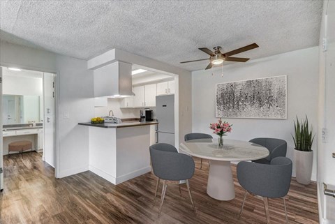 a dining room and kitchen with a table and chairs
